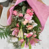 Pink mixed bouquet with roses, lilies, and carnations wrapped in pink paper