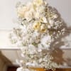 White rose bouquet with baby's breath cascading downward