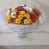 Bouquet of mixed daisies and chrysanthemums in white, yellow, orange, and red
