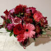 Mixed bouquet of red and pink flowers in a vase