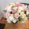 Pink and white rose bouquet with a white daisy in a vase