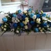 Large blue, white, and purple floral arrangement on a table