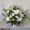 White rose and daisy arrangement in a white vase