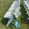 White chair decorated with a blue and white floral bouquet