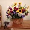 Large mixed flower arrangement in a woven basket