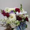 Mixed bouquet of red, white, purple, and blue flowers