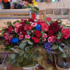 Large mixed bouquet with pink and red flowers and blue accents