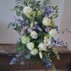 A serene standing spray inspired by soft ocean colors, featuring white blooms
