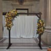 Sunflower floral arch with white daisies on a wooden frame