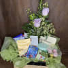 Lavender roses in a gift basket with chocolates and tea