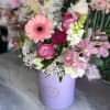 Pink and white mixed flower arrangement in a lavender box