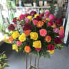 Large bouquet of multicolored roses on a tall stand