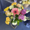 Mixed bouquet with pink gerbera, purple roses, and yellow blooms