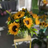 Bouquet of yellow sunflowers in a glass vase