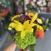 Bouquet with yellow lily, green hydrangea, and mixed purple and orange flowers