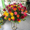 Large bouquet of multicolored roses on a tall stand