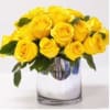 Yellow roses arranged in a clear glass vase