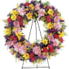 Colorful floral wreath on a metal easel stand