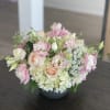 Pink and cream bouquet in a dark vase