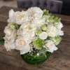White and blush bouquet in a green glass vase