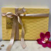 Gift box of Godiva chocolates tied with a satin ribbon and orchid bloom