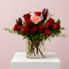 Bouquet of red and pink roses in a clear glass vase