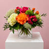 Bright mixed bouquet of roses and hydrangeas in a clear glass vase