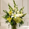 White and green floral arrangement in a glass vase