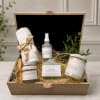 Gift box with mint eucalyptus bath items, a towel, and a candle