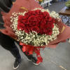 Bouquet of red roses with white baby's breath in red wrap