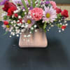 Pink and red mixed bouquet in a blush vase