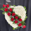 Heart-shaped standing spray of red roses and white chrysanthemums