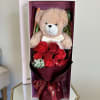 Teddy bear with red roses in a gift box