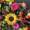 Mixed bouquet with sunflowers, roses, and a pink gerbera daisy