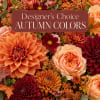 Autumn flower arrangement with orange, burgundy, and peach blooms