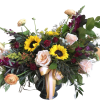 Mixed bouquet with sunflowers, roses, and purple blooms in a dark vase