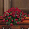 Casket spray of red roses with greenery