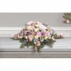 Pastel floral casket spray with pink, white, and yellow blooms