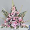 Tall pink and white floral arrangement in a white vase