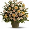 Arrangement of pale roses and carnations in a textured vase