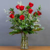 Red roses arranged in a clear glass vase