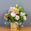 Peach and white rose bouquet in a gold box vase
