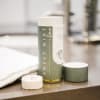 Mint + Lime scented candle in a green cylindrical container with a lid