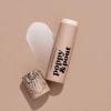 Two lip balm tubes with one cap off and a white balm stick exposed