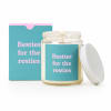 Lit candle in a glass jar with a matching box