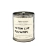 Soy wax candle in a metal tin labeled Fresh Cut Flowers