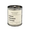 Metal tin candle labeled fresh brewed coffee