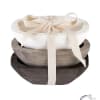 Stacked wooden bowls tied with a cream ribbon