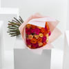 Bouquet of orange and pink roses wrapped in pale pink paper