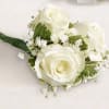 White rose boutonniere with baby's breath and green wrap